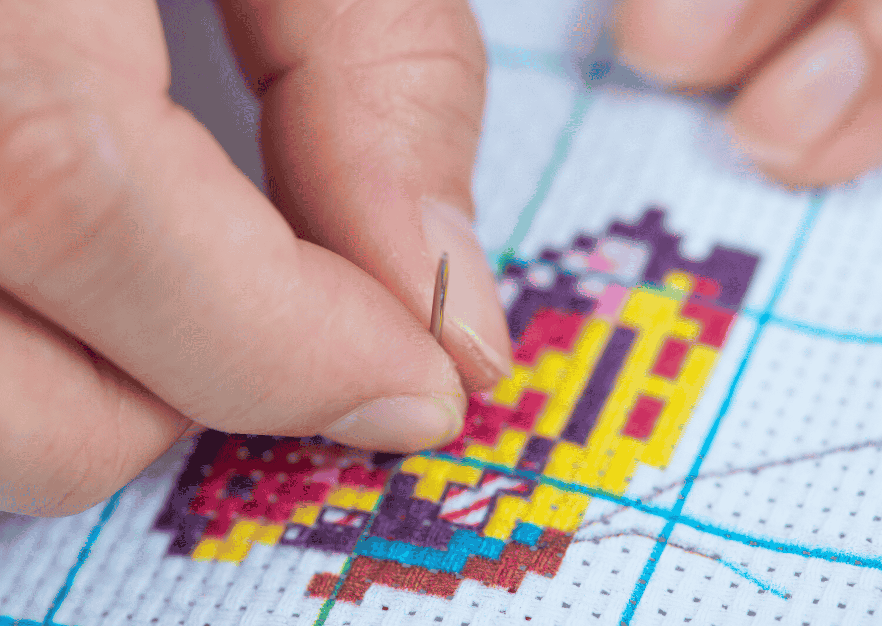 A partially completed embroidery canvas symbolizing the cross-stich metaphor for life on mission