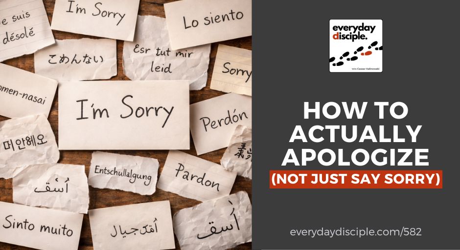 Handwritten paper scraps featuring the words “I’m sorry” in different languages lie on a wooden surface, illustrating apology across cultures.