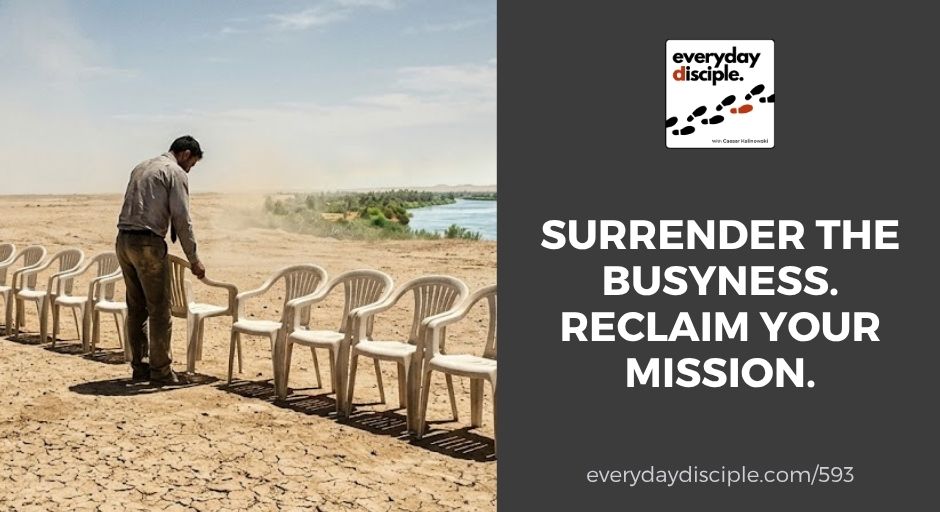 A man places plastic chairs in a row on dry land near a riverbank, symbolizing preparation and purpose.