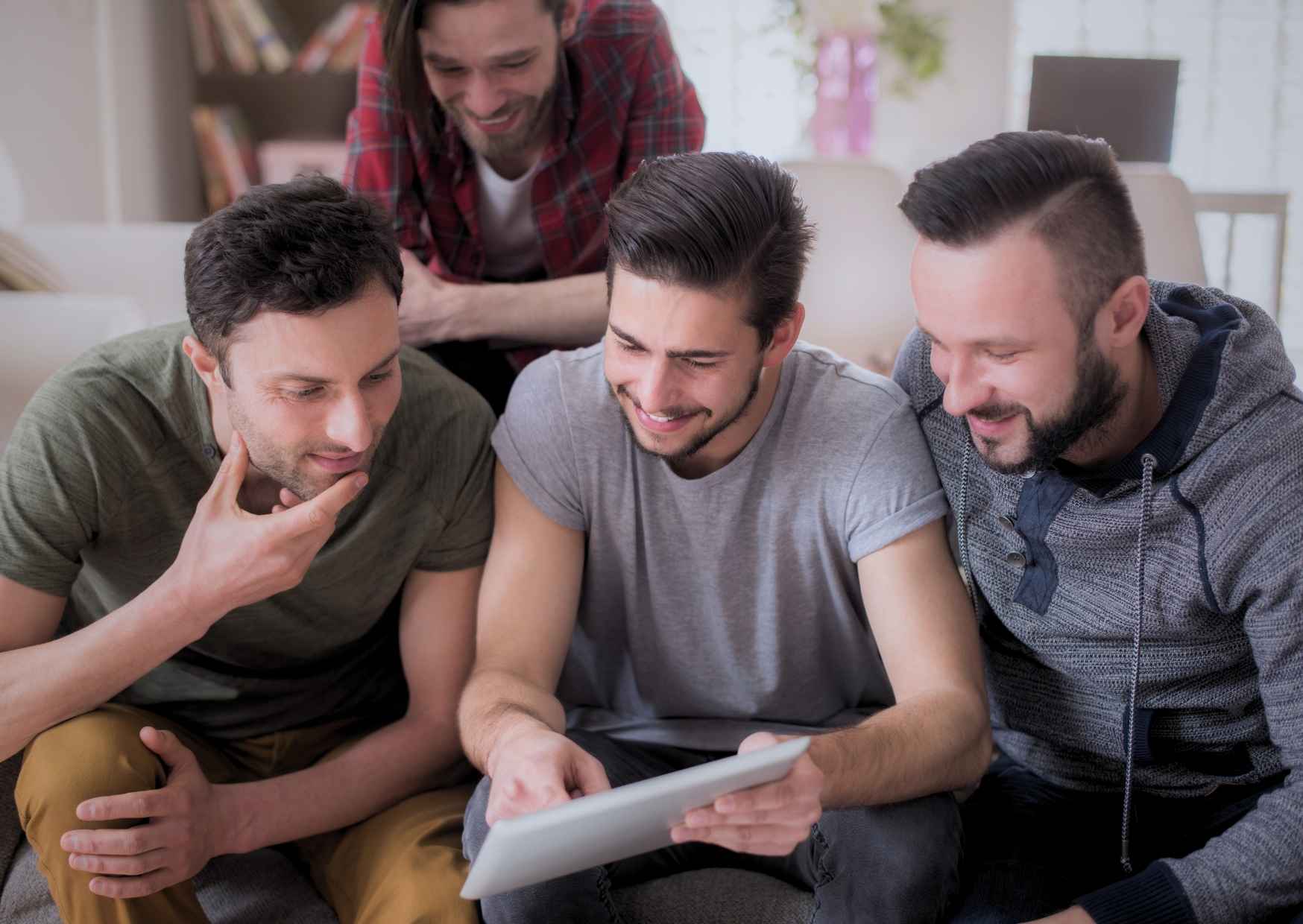 Friends having a natural conversation at a living room sofa