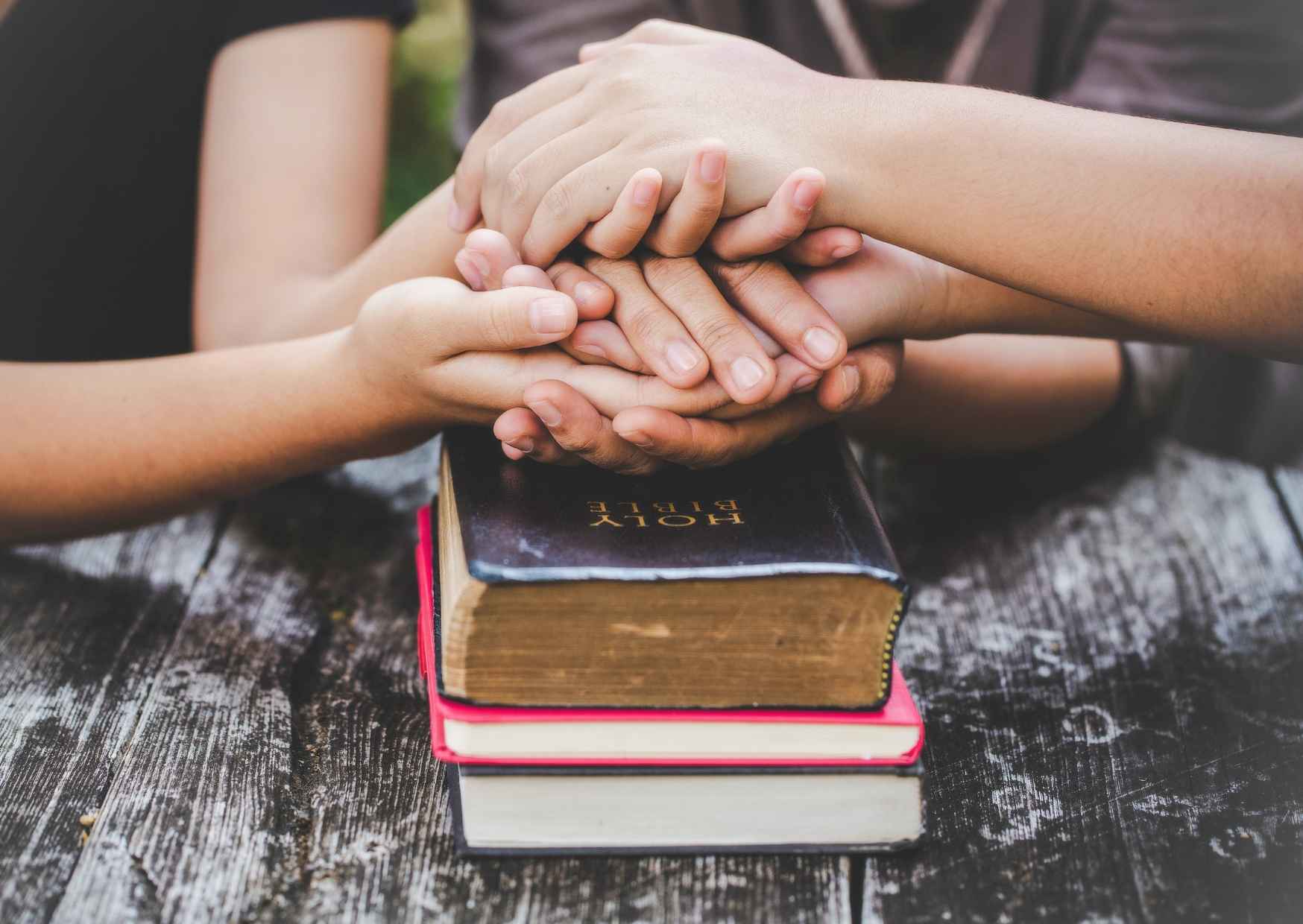 Discipleship and Evangelism Are Not Two Things hands on top of bible