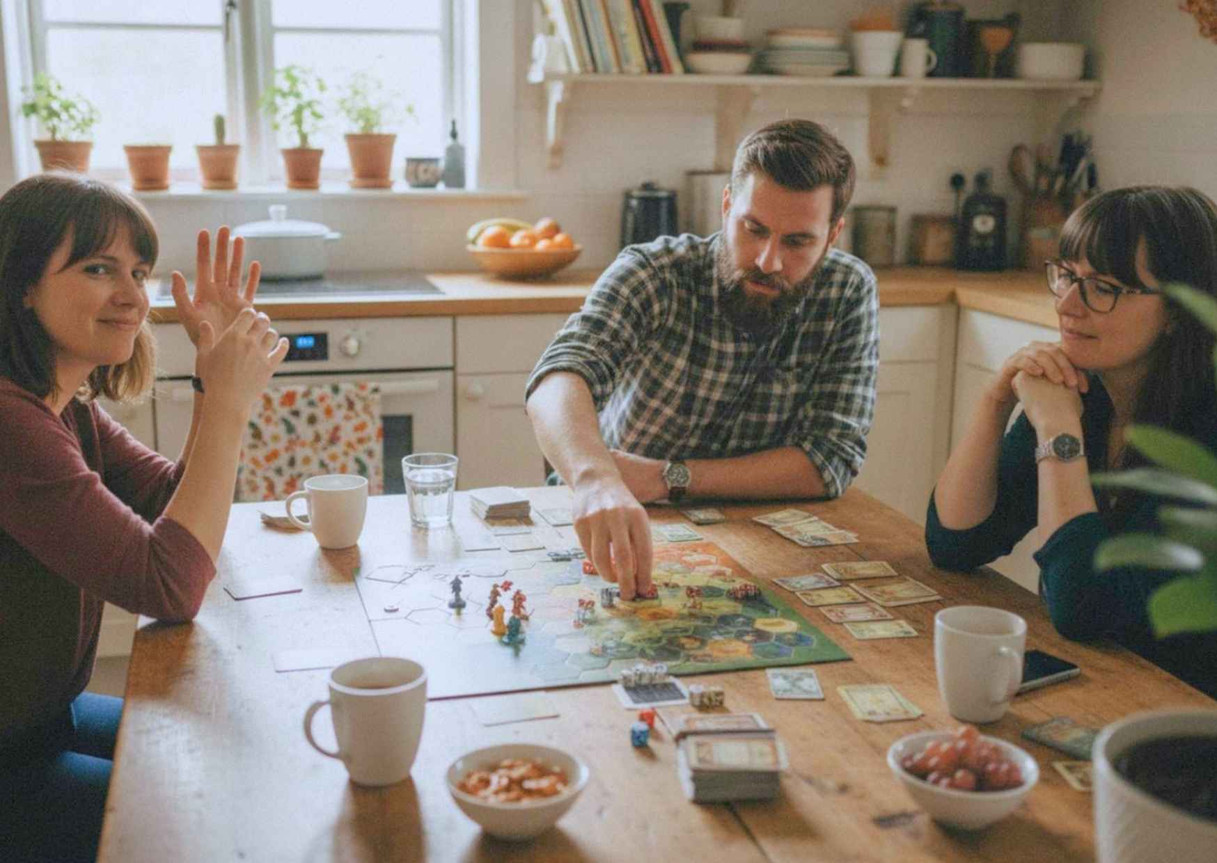 Three adults mid-game around a kitchen table